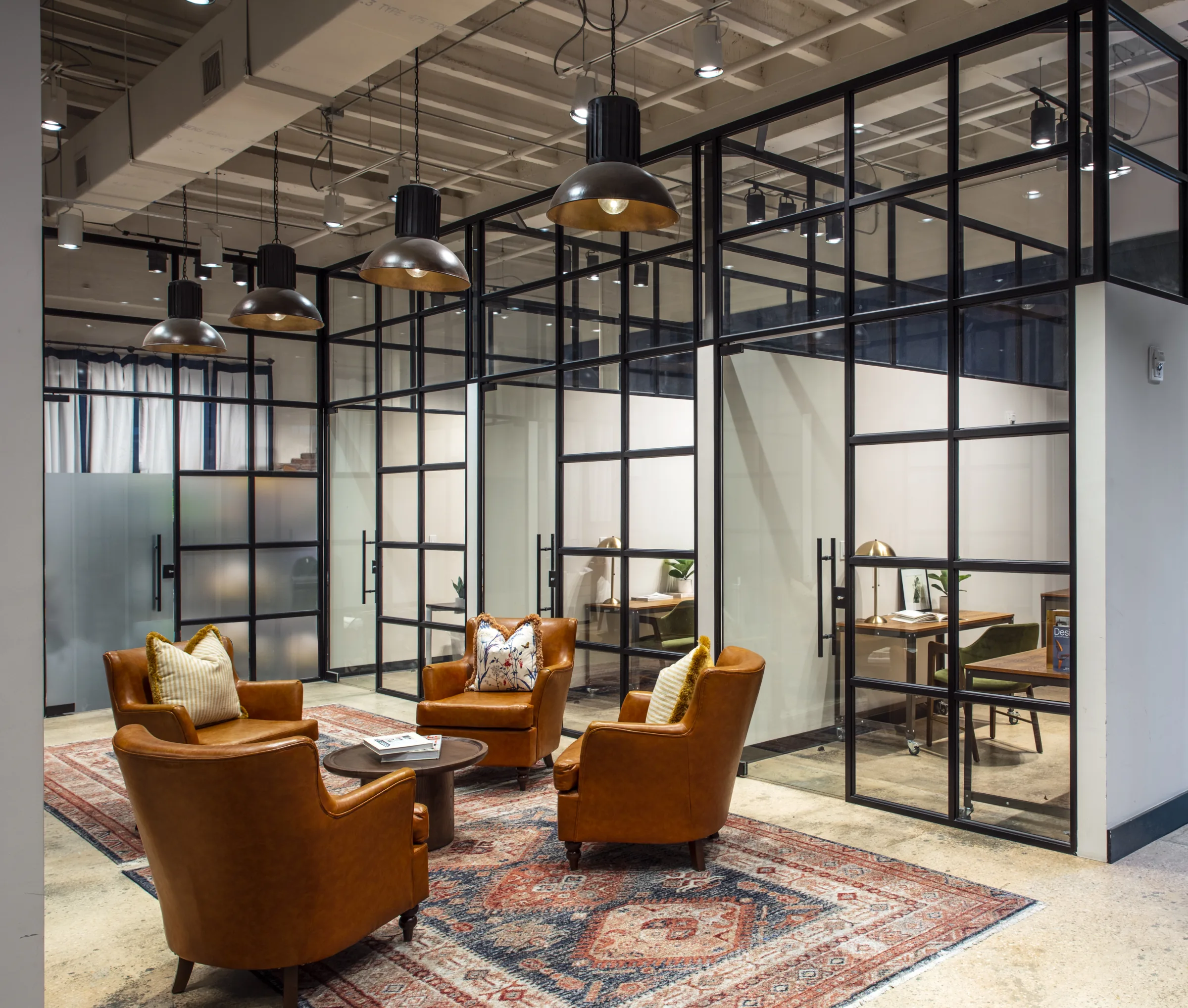 Members lounge and glass-front private offices at Ampersand Studios Miami